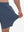 View showing loose fit of misty blue breathable running shorts with 4 zipper pockets