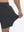 View showing loose fit of dark grey breathable running shorts with 4 zipper pockets