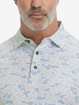 Close-up from nose to chest, showing collar and fabric pattern detail of the brown & gray camo polo shirt.