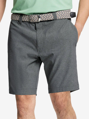 Front view of youth wearing dark grey Heather Performance Golf Shorts, showing fit and style