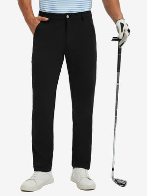 Lightweight moisture wicking dress pants in black, front lower-body with model leaning on golf club.