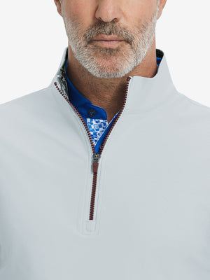 Close-up from nose to chest, showing collar detail and zipper of the misty grey golf vest.