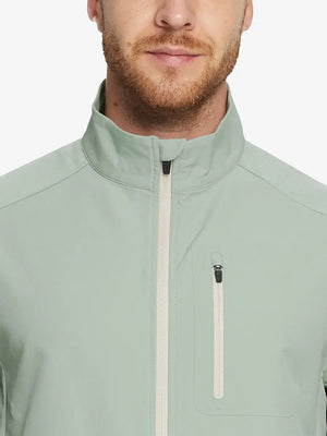 Model showcases the light green windproof golf vest, highlighting its vibrant color and functional pockets.