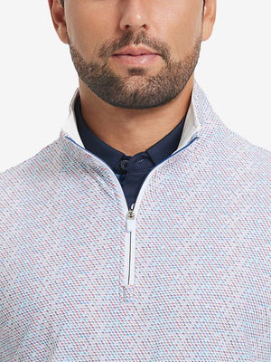 Close-up from nose to chest, showing zipper collar detail and fabric pattern of the colorful hexagon pullover.
