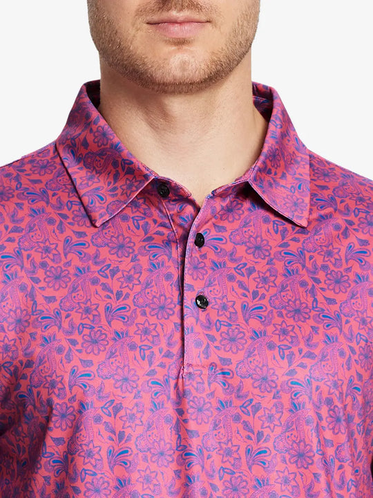 Coral paisley pattern polo shirt, model displays the elegant and soft design in a flattering front view.