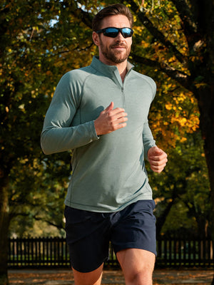 Model outdoor sports activity shooting scene, dry fit athletic 1/4 zip sweatshirt in celadon green heather