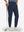 Front lower body shot of model wearing navy flat front golf joggers pants with belt loops