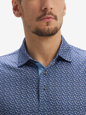 Close-up of lower face and upper shirt in Performance quick dry print golf polos, navy white floral detail