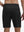 Back lower body shot of model wearing black breathable running shorts with 4 zipper pockets