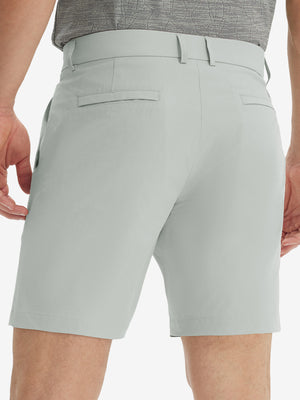 Back lower body view of model wearing the light grey stretch soft flat front dress golf shorts, highlighting the rear design
