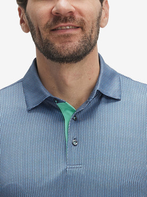 Close-up of lower face and upper shirt in Performance quick dry print golf polos, navy light blue ovals detail