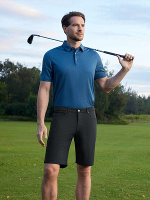Model holding a golf club on course, styled in 4-way stretch performance solid shorts with black