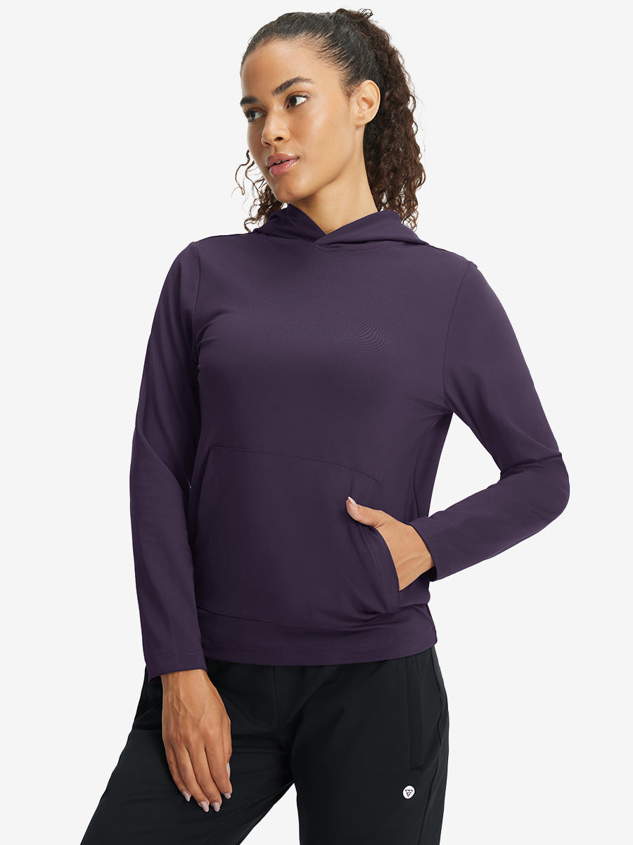 Model with one hand in side pocket wearing women's lightweight hoodies pullover in dark purple.