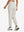 Model wearing women's stretch fleece lined water resistant joggers in oyster gray, showing the back lower body view.