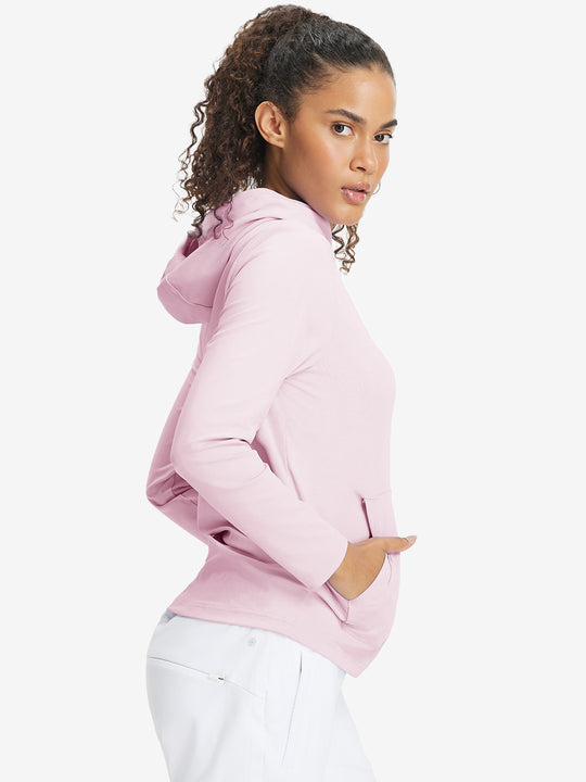 Model with one hand in side pocket wearing women's lightweight hoodies pullover in pale pink.