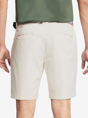 Back waist to knee view of beige water resistant golf 9 inch shorts, flexible performance fit.