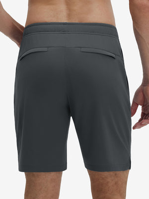 Back lower body shot of model wearing dark grey breathable running shorts with 4 zipper pockets