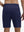 Back lower body shot of model wearing navy breathable running shorts with 4 zipper pockets