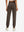 Model wearing women's stretch fleece lined water resistant joggers in coffee brown, showing the back lower body view.