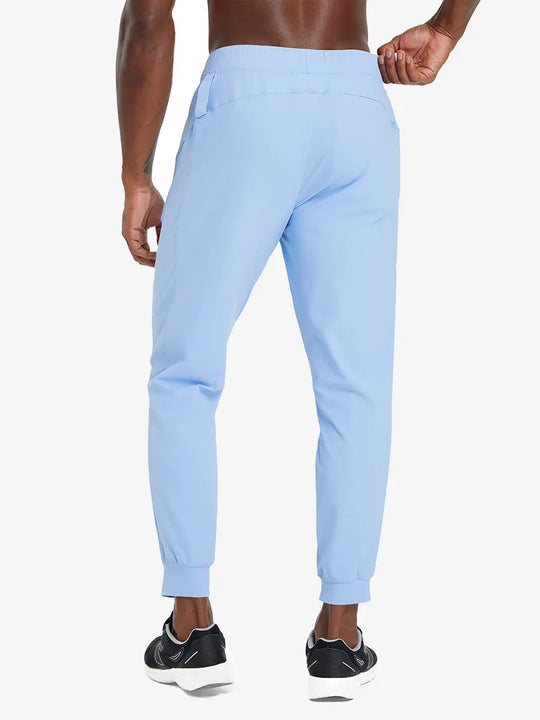 Back lower body view of model wearing LIGHT BLUE Performance Tapered Sports Joggers