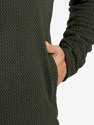 Close-up of pocket detail on midweight warm stretchy quarter zip pullover in forest green, showing neat stitching.