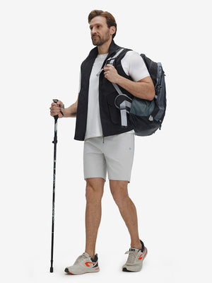 Front full body shot of model exercising in khaki grey breathable running shorts with 4 zipper pockets