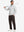 Full-body shot of model holding a golf club while wearing coffee brown thermal water repellent fleece dress pants
