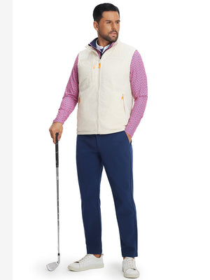Full-body shot of model with golf club wearing navy water-resistant stretch heat-tech winter trousers