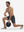 Front full body shot of model exercising in dark grey breathable running shorts with 4 zipper pockets