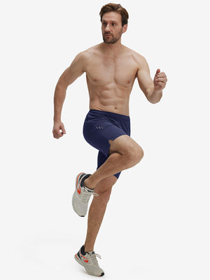 Front full body shot of model exercising in navy breathable running shorts with 4 zipper pockets