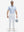 Front full body shot of model wearing white flat front golf joggers pants with belt loops