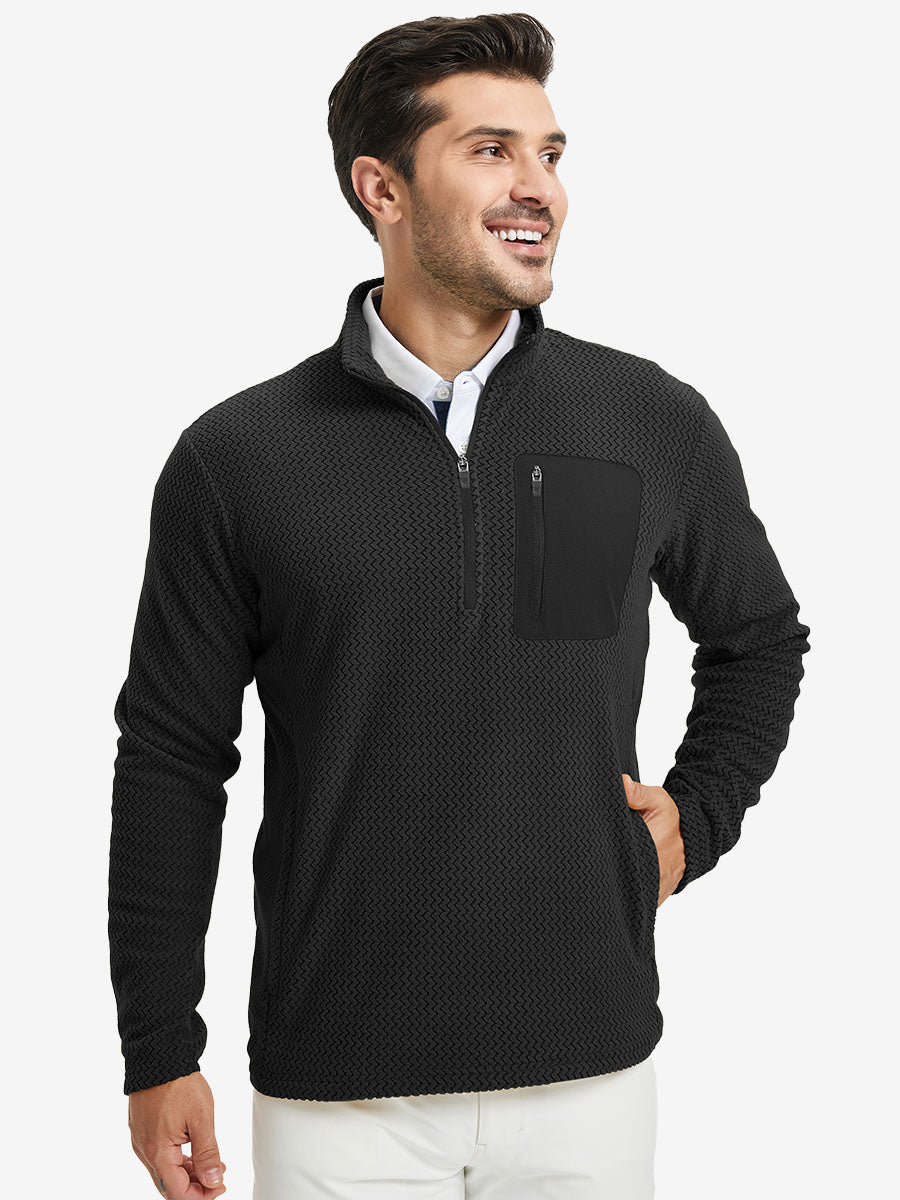 Model with one hand in side pocket, wearing midweight warm stretchy quarter zip pullover in black.
