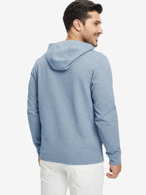 Back view of model wearing texture solid hoodies pullover showing fit and hood detail, blue heather.