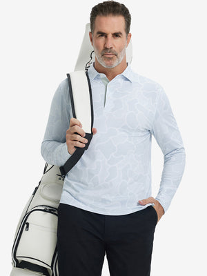 Model carrying golf bag, styled in light gray irregular pattern lightweight print long sleeve polo, sleek golf outfit.