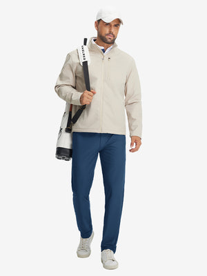 Model carrying a tennis bag, wearing blue indigo lightweight flat front casual trousers in full-body view.