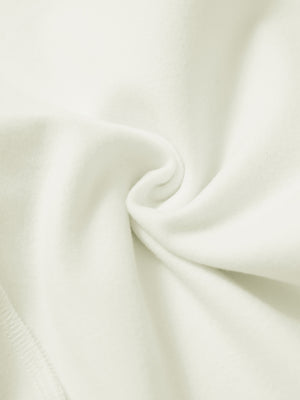 Fabric close-up of cream water resistant comfy fleece golf joggers, soft fleece texture with water-resistant finish.