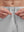 Detail view of elastic waistband on khaki grey breathable running shorts with 4 zipper pockets