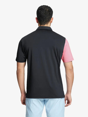 Back half-body view of model in BLACK Moisture Wicking Color Block Polo Shirt.