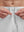 Detail view of elastic waistband on white breathable running shorts with 4 zipper pockets