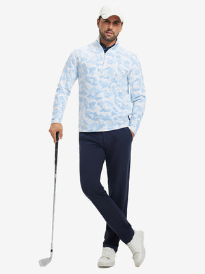 Full-body shot of model holding golf club, dressed in full print quarter zip pullover in sky blue camo.