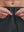 Detail view of elastic waistband on dark grey breathable running shorts with 4 zipper pockets
