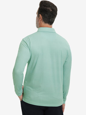Back upper body view of the lightweight print polo in green plant, model turns slightly with relaxed pose.