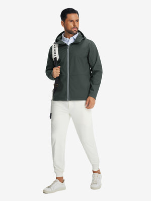 Model with backpack, wearing reflective hooded softshell jacket in grey, full-body outdoor look.