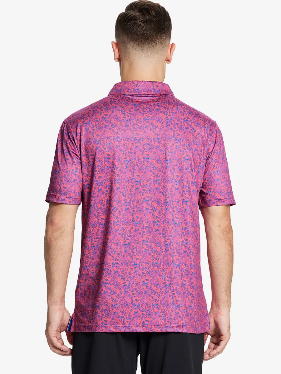 Back view of the model showcasing the coral paisley pattern polo, highlighting its elegant design and sporty feel.