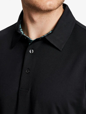 Male model wearing the Black Everyday Classic Solid Polo, front view from nose to chest