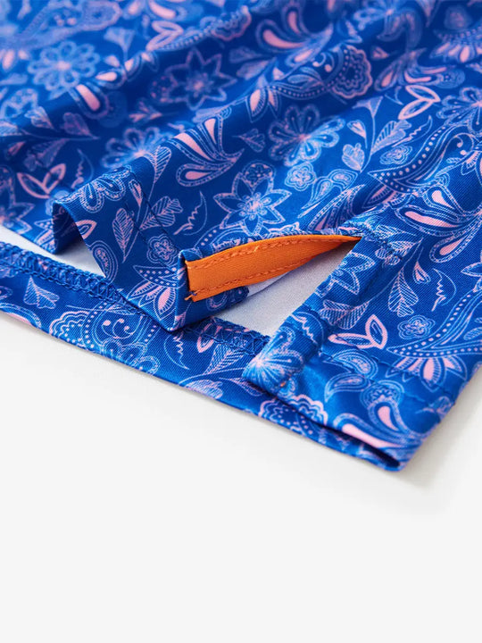 Detailed image shows the corner design of the navy blue paisley patterned model polo shirt, a clever blend of vintage style and modern sporty style, to enhance the wearing comfort and fashion sense.
