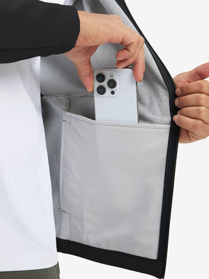 Hand placing an iPhone into pocket of water-resistant heat-tech softshell winter jacket with hood.