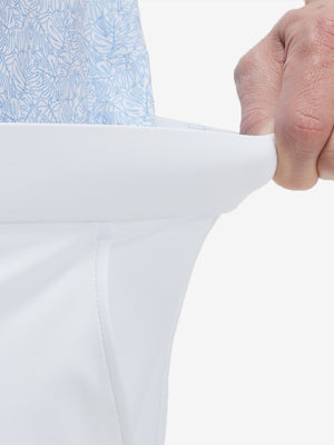 Detail view of elastic waistband on white flat front golf joggers pants with belt loops