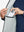 Inner pocket detail of Lightweight Water Resistant Puffer Vest in light grey heather, holding smartphone