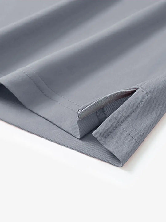 Detail view of the light grey long sleeve pique polo, showcasing the hem opening and relaxed design.